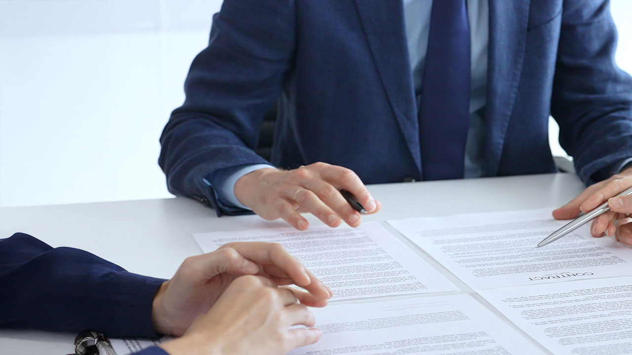Attorney reviewing a contract document in a professional office setting