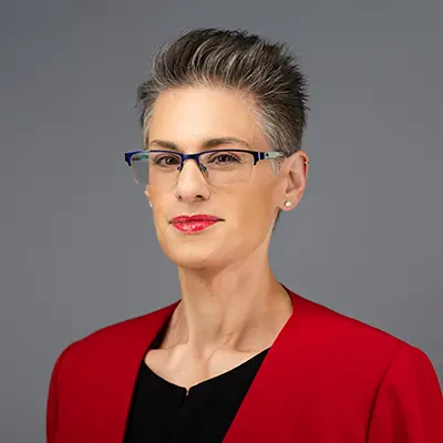 Professional portrait of female family law attorney wearing red blazer at Heymann & Fletcher law firm