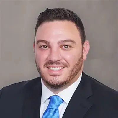 Professional headshot of a family law attorney in a suit and blue tie at Heymann & Fletcher law firm