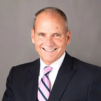 Professional headshot of senior litigation attorney in suit and pink tie at Heymann & Fletcher law firm
